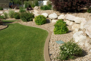 a garden with rocks and grass in the middle